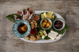 A plate of cheeses, cured meat and fruit prepared by chef Giovanna Voria, 63 years old inside the kitchen of the Corbella farmhouse in Cicerale, Southern Italy on October 3, 2021. Giovanna Voria is an ambassador of the Mediterranean diet in the world, which according to many studies is the basis of longevity. This type of diet involves the consumption of almost exclusively plant foods that are rich in antioxidant biomolecules and protect against the onset of many chronic diseases.