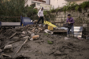 Two men at work to remove mud from the street the day after a landslide hit the Italian holiday island of Ischia, Southern Italy on November 27, 2022.