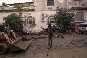 A man at work to remove mud from the street following a landslide hit the Italian holiday island of Ischia, Southern Italy on November 27, 2022.