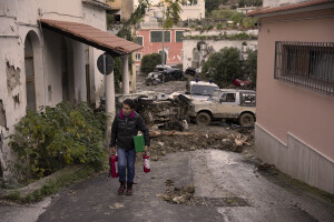 A woman walks in the street the day after a landslide hit the Italian holiday island of Ischia, Southern Italy on November 27, 2022.