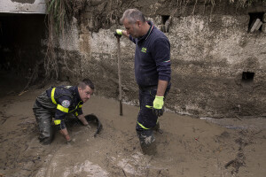 Civil protection operators at work to remove mud from a factory following a landslide hit the Italian holiday island of Ischia, Southern Italy on November 27, 2022.