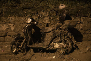 A motorcycle covered in mud and debris is seen following a landslide on the Italian holiday island of Ischia, Southern Italy on November 26, 2022.