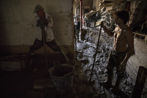 People at work to remove mud from a factory following a landslide hit the Italian holiday island of Ischia, Southern Italy on November 28, 2022.