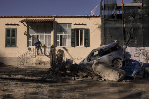 A man looks at destroyed cars the day after a landslide hit the Italian holiday island of Ischia, Southern Italy on November 27, 2022.