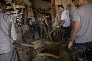 People at work to remove mud from a factory following a landslide hit the Italian holiday island of Ischia, Southern Italy on November 28, 2022.