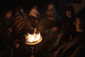 People are seen around a fire in Kahramanmaras, Turkey on February 14, 2023. On February 6, 2023 a powerful earthquake measuring 7.8 struck southern Turkey killing more than 50,000 people.