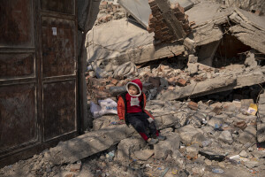 A child sits on the rubble of a destroyed building in Kahramanmaras, Turkey on February 18, 2023. On February 6, 2023 a powerful earthquake measuring 7.8 struck southern Turkey killing more than 50,000 people.