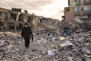An old man walks among the rubble of destroyed buildings in Hatay, Turkey on February 15, 2023. On February 6, 2023 a powerful earthquake measuring 7.8 struck southern Turkey killing more than 50,000 people.