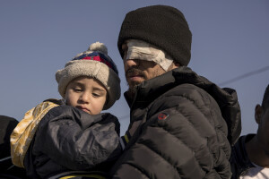 A Syrian man with an injured eye and his son effected by the earthquake are seen before crossing from Turkey’s Cilvegozu border crossing to Syria’s Bab al_Hawa border crossing in Reyhanli, Turkey on February 17, 2023. Following the earthquake that struck southern Turkey on February 6, 2023 killing more than 50,000 people, thousands of Syrian refugees living in Turkey decided to return to their country of origin.