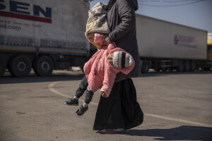 A Syrian woman carries her daughter by the arm before crossing from Turkey’s Cilvegozu border crossing to Syria’s Bab al_Hawa border crossing in Reyhanli, Turkey on February 17, 2023. Following the earthquake that struck southern Turkey on February 6, 2023 killing more than 50,000 people, thousands of Syrian refugees living in Turkey decided to return to their country of origin.