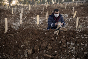 A man mourns the death of his relative inside a cemetery in Kahramanmaras, Turkey on February 13, 2023. On February 6, 2023 a powerful earthquake measuring 7.8 struck southern Turkey killing more than 50,000 people.