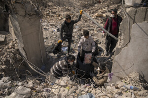 People extract items in the rubble of a destroyed shop in Kahramanmaras, Turkey on February 18, 2023. On February 6, 2023 a powerful earthquake measuring 7.8 struck southern Turkey killing more than 50,000 people.