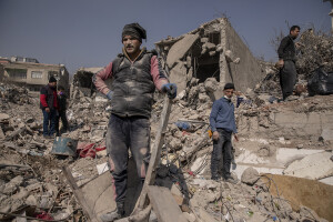 People are seen in the rubble of destroyed buildings in Kahramanmaras, Turkey on February 18, 2023. On February 6, 2023 a powerful earthquake measuring 7.8 struck southern Turkey killing more than 50,000 people.