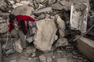 A man walks among the rubble of collapsed buildings in Hatay, Turkey on February 15, 2023. On February 6, 2023 a powerful earthquake measuring 7.8 struck southern Turkey killing more than 50,000 people.