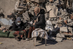 Two women sit near the rubble of a collapsed bulding in Kahramanmaras, Turkey on February 13, 2023. On February 6, 2023 a powerful earthquake measuring 7.8 struck southern Turkey killing more than 50,000 people.