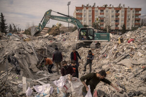 People extract items in the rubble of a destroyed shop in Kahramanmaras, Turkey on February 19, 2023. On February 6, 2023 a powerful earthquake measuring 7.8 struck southern Turkey killing more than 50,000 people.