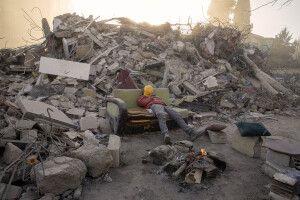 A worker rests on a sofa among the rubble of destroyed buildings in Kahramanmaras, Turkey on February 16, 2023. On February 6, 2023 a powerful earthquake measuring 7.8 struck southern Turkey killing more than 50,000 people.