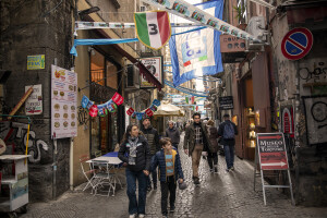 People walk through the streets decorated in blue to celebrate the victory of Napoli’s third championship in the historical center of Naples, Southern Italy on April 6, 2023.