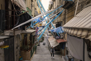 A woman walks through the streets decorated in blue to celebrate the victory of Napoli’s third championship at Spanish neighborhoods in Naples, Southern Italy on April 3, 2023.