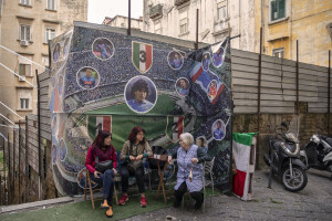 Women are seen near a big poster depicting the players of the Napoli soccer team at Spanish neighborhoods in Naples, Southern Italy on April 24, 2023.