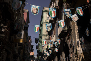 Photographs of the players of the Napoli soccer team and tricolor badges hang between the buildings of the historical center of Naples, Southern Italy on April 20, 2023.