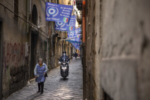 A woman walks through the streets decorated in blue to celebrate the victory of Napoli’s third championship in the historical center of Naples, Southern Italy on April 20, 2023.