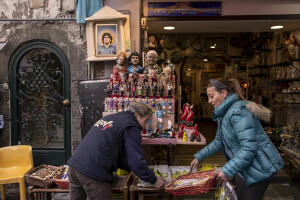 People at work near statuettes depicting the Argentine soccer legend Diego Armando Maradona in San Gregorio Armeno street in Naples, Southern Italy on November 23, 2021. Diego Armando Maradona died on November 25 of last year and next November 25, 2021 will be the anniversary of his death.