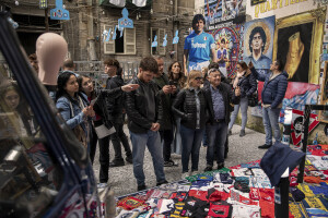 People look at the shirts, photographs and all the memorabilia of Argentine footballer Diego Armando Maradona at Spanish neighborhoods in Naples, Southern Italy on April 24, 2023.