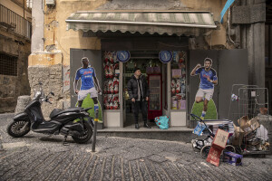 A boy is portrayed near the giant prints of the Georgian footballer and Napoli striker Khvicha Kvaratskhelia and the Nigerian footballer and Napoli striker Victor Osimhen at the Spanish neighborhoods in Naples, Southern Italy on April 3, 2023.