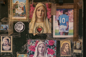 A photograph of the Argentine soccer legend Diego Armando Maradona is seen near religious iconography on a shop door at Spanish neighborhoods in Naples, Southern Italy on April 3, 2023.