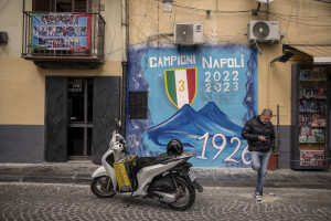 A man is seen near a mural depicting a blu volcano to celebrate the victory of Napoli’s third championship in Sanità district in Naples, Southern Italy on April 6, 2023.