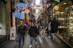 People walk through the streets decorated in blue to celebrate the victory of Napoli’s third championship in the historical center of Naples, Southern Italy on April 6, 2023.