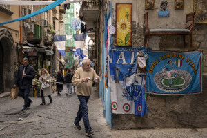 People walk through the streets decorated in blue to celebrate the victory of Napoli’s third championship in the Spanish Quarter in Naples, Southern Italy on April 3, 2023.