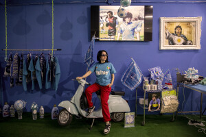 A girl is portrayed inside a shop that sells gadgets of the Napoli football team at Spanish neighborhoods in Naples, Southern Italy on April 3, 2023.