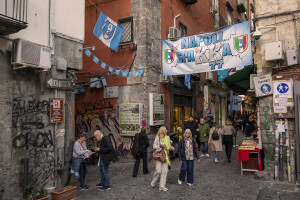 People walk through the streets decorated in blue to celebrate the victory of Napoli’s third championship  in the historical center of Naples, Southern Italy on April 20, 2023.