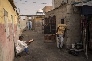 A boy studies the Quran in front of the Koranic school located near the sea in the “Langue de Barbarie” in Saint-Louis, Senegal on December 12, 2023. The “Langue de Barbarie” is a thin, sandy peninsula located in western Senegal, where around 80,000 people live and is among the places most threatened by the rise in sea levels generated by climate change. The peninsula separates the Atlantic ocean from the final section of the Senegal river.