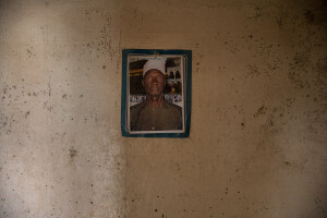 A photo of Abdou Rahmane Gueye (died 2007) hangs on the wall of the house he built in the 1990s in front of the sea in Bargny, Senegal on December 16, 2023. In the past the house was larger, but the sea partially destroyed it. Two or three times a year it happens that sea water reaches inside the house. The coastal erosion began in the 1980s but worsened in the early 2000s. Storm surges have become more common and fiercer, like the passage of Hurricane Fred in the night of August 30, 2015. Bargny is currently losing three to four meters of coast each year.