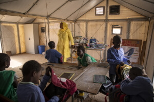 Children are seen during a french lesson inside the school of the Djougop temporary camp for internally displaced people who lost their homes due to coastal erosion in Saint-Louis, Senegal on December 13, 2023. At Djougop temporary camp located seven miles inland people live in small tents without bathrooms and electricity. Toilets and taps for running water are shared.