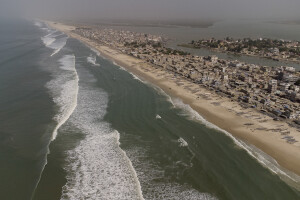 A general view of the “Langue de Barbarie” in Saint-Louis, Senegal on December 14, 2023. The “Langue de Barbarie” is a thin, sandy peninsula located in western Senegal, where around 80,000 people live and is among the places most threatened by the rise in sea levels generated by climate change. The peninsula separates the Atlantic ocean from the final section of the Senegal river.