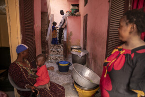 Ndiagamar, 19 years old (center) plays with his niece Fatou Kiné Seck, 5 years old (center) while his sister Rokhaya, 32 years old (left) holds her son Ahmadou, 5 months old and his other sister Mame Diarra Diouf, 28 years old (right) watches them in the house where they live in Saint-Louis, Senegal on December 14, 2023. Due to the risks associated with rising sea levels, in August 2023 Ndiagamar tried to go to Spain by sea. To do this he entrusted himself to a group of traffickers and paid 400,000 senegalese francs to board a boat which was headed to Spain, but the journey stopped between Morocco and Mauritania due to bad weather conditions. The boat trip in which every year hundreds of people risk everything to leave Senegal and go to Spain is called by the local population “Barça ou barsakh”, which means “Barcelona or death”.