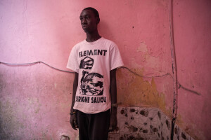 Ndiagamar, 19 years old is portrayed inside the house where he live in Saint-Louis, Senegal on December 14, 2023. Due to the risks associated with rising sea levels, in August 2023 Ndiagamar tried to go to Spain by sea. To do this he entrusted himself to a group of traffickers and paid 400,000 senegalese francs to board a boat which was headed to Spain, but the journey stopped between Morocco and Mauritania due to bad weather conditions. The boat trip in which every year hundreds of people risk everything to leave Senegal and go to Spain is called by the local population “Barça ou barsakh”, which means “Barcelona or death”.