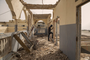 A worker is seen inside the Cheick Tourè school in Saint-Louis, Senegal on December 11, 2023. In March 2018 the school was closed following a weather warning and only a few days later part of the structure was destroyed by sea waves. Today, work is underway for the definitive demolition of the building.