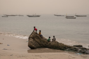 Children play on an old barrier built around 1988 to stop the advance of the sea in Bargny, Senegal on December 19, 2023. The coastal erosion began in the 1980s but worsened in the early 2000s. Storm surges have become more common and fiercer, like the passage of Hurricane Fred in the night of August 30, 2015. Bargny is currently losing three to four meters of coast each year.