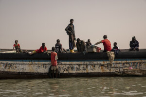 Fishermen collect the day’s catch from a pirogue along the coast of the Senegal River in Saint-Louis, Senegal on December 14, 2023. Climate change also affects fishing, a key sector in Senegal which represents 3.2% of the country’s GDP (gross domestic product). The increase in water temperatures is having repercussions on marine ecosystems (changes in the migrations and habits of many fish species) which, in addition to the intensive fishing practiced by foreign fishing boats, is reducing the country’s fish resources. Furthermore, the advance of the sea is forcing many fishermen in Saint-Louis to leave their homes facing the sea and move inland: now to reach the sea and go fishing they have to face long and expensive journeys.