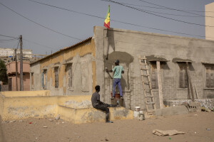 Two men at work to reinforce the external walls of a house and defend it from the possible arrival of sea waves in the “Langue de Barbarie” in Saint-Louis, Senegal on December 12, 2023. The “Langue de Barbarie” is a thin, sandy peninsula located in western Senegal, where around 80,000 people live and is among the places most threatened by the rise in sea levels generated by climate change. The peninsula separates the Atlantic ocean from the final section of the Senegal river.