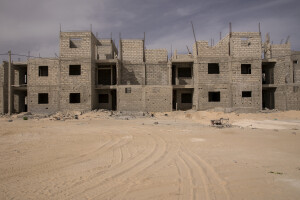 Houses under construction near the Djougop temporary camp for internally displaced people who lost their homes due to coastal erosion in Saint-Louis, Senegal on December 15, 2023. The homes will accommodate people living in the houses facing the sea, which are considered to be at high risk of flooding.