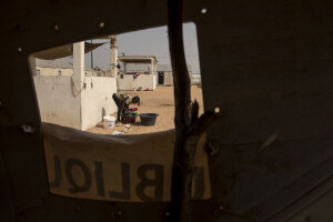 A girl washes clothes inside the Djougop temporary camp for internally displaced people who lost their homes due to coastal erosion in Saint-Louis, Senegal on December 13, 2023. At Djougop temporary camp located seven miles inland people live in small tents without bathrooms and electricity. Toilets and taps for running water are shared.