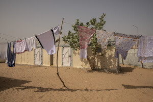 Clothes hanging to dry inside the Djougop temporary camp for internally displaced people who lost their homes due to coastal erosion in Saint-Louis, Senegal on December 13, 2023. At Djougop temporary camp located seven miles inland people live in small tents without bathrooms and electricity. Toilets and taps for running water are shared.