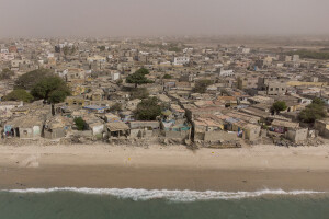 Houses heavily damaged by sea waves along the coast in Bargny, Senegal on December 19, 2023. The coastal erosion began in the 1980s but worsened in the early 2000s. Storm surges have become more common and fiercer, like the passage of Hurricane Fred in the night of August 30, 2015. Bargny is currently losing three to four meters of coast each year.
