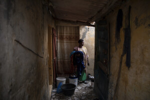 Rama, 42 years old is portrayed inside her house facing the sea in the “Langue de Barbarie” in Saint-Louis, Senegal on December 11, 2023. Rama fears that her house, already damaged by sea waves in 2019, may suffer further damage in the future. The “Langue de Barbarie” is a thin, sandy peninsula located in western Senegal, where around 80,000 people live and is among the places most threatened by the rise in sea levels generated by climate change. The peninsula separates the Atlantic ocean from the final section of the Senegal river.